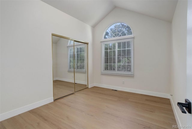 6055 W Warren, Lakewood, CO 80227 - unfurnished bedroom featuring light wood-style flooring, vaulted ceiling, and a closet
