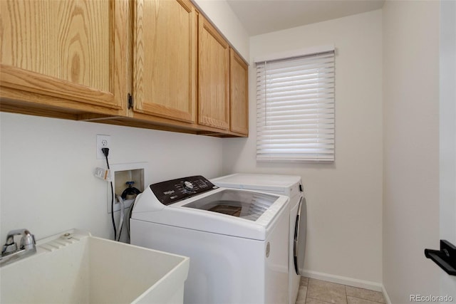 6055 W Warren, Lakewood, CO 80227 - laundry area featuring cabinet space, independent washer and dryer, and light tile patterned floors