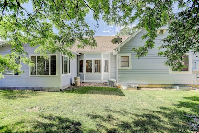 6055 W Warren, Lakewood, CO 80227 - back of house with a yard and roof with shingles