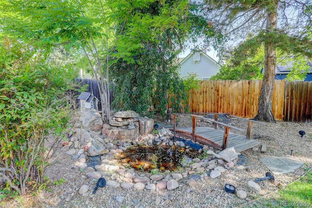6055 W Warren, Lakewood, CO 80227 - fenced backyard featuring a deck