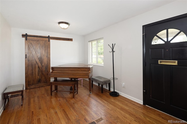 745 S Glencoe St, Denver, CO 80246 - entryway featuring wood finished floors and a barn door