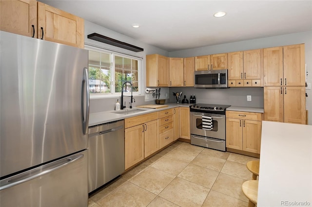 745 S Glencoe St, Denver, CO 80246 - kitchen with stainless steel appliances, light brown cabinets, light countertops, light tile patterned flooring, and recessed lighting