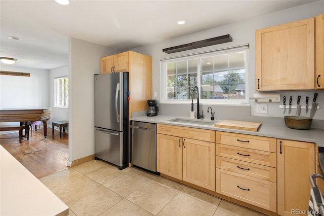 745 S Glencoe St, Denver, CO 80246 - kitchen with light brown cabinetry, stainless steel appliances, light countertops, recessed lighting, and light tile patterned floors