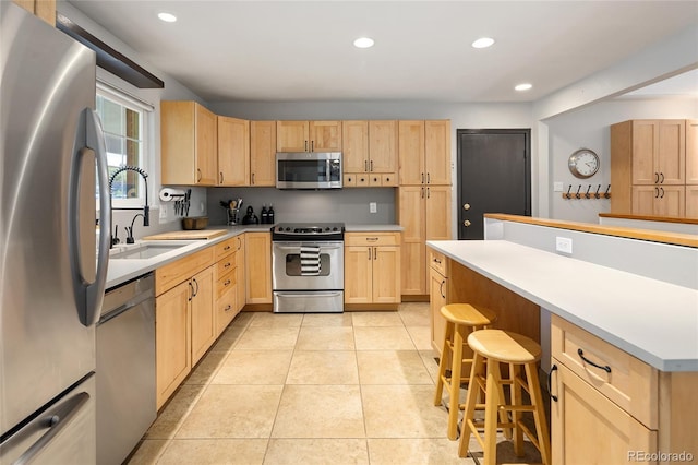 745 S Glencoe St, Denver, CO 80246 - kitchen with stainless steel appliances, light brown cabinets, light countertops, and recessed lighting