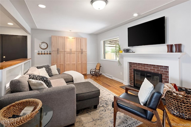 745 S Glencoe St, Denver, CO 80246 - living room with light wood-type flooring, a brick fireplace, and recessed lighting