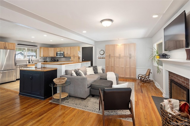 745 S Glencoe St, Denver, CO 80246 - living area featuring light wood-type flooring, a fireplace, and recessed lighting