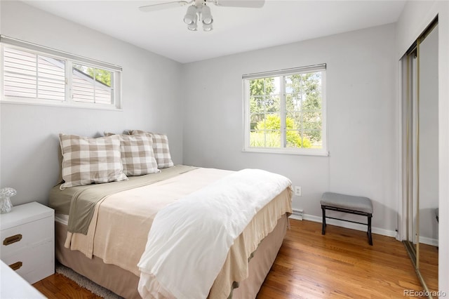 745 S Glencoe St, Denver, CO 80246 - bedroom with light wood-type flooring, a ceiling fan, and a closet