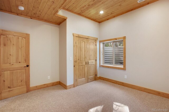 unfurnished bedroom featuring light carpet and wood ceiling