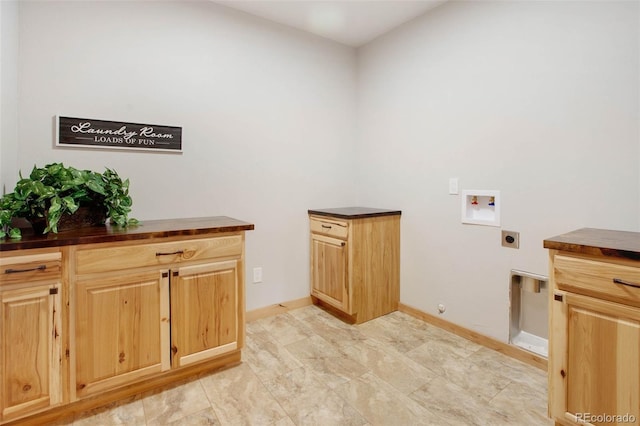 laundry area with electric dryer hookup, hookup for a washing machine, and cabinets