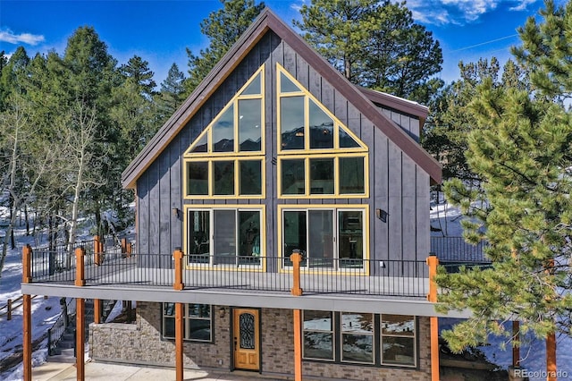 rear view of property featuring a balcony