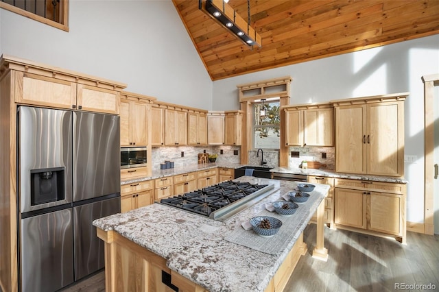 kitchen featuring appliances with stainless steel finishes, light stone counters, wood ceiling, high vaulted ceiling, and a center island