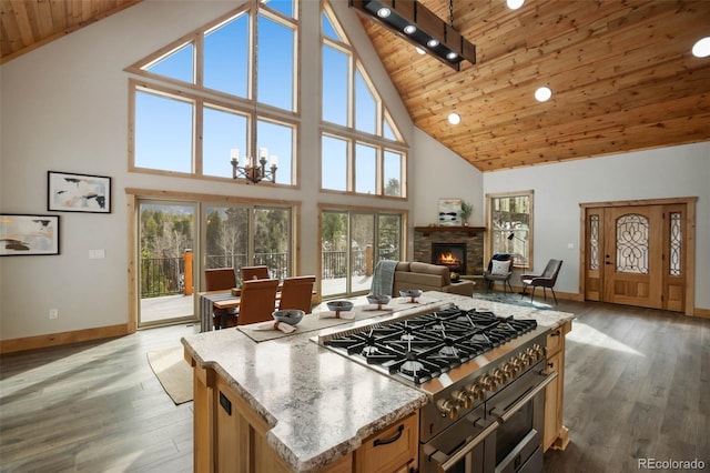 kitchen with dark hardwood / wood-style flooring, high end range, high vaulted ceiling, and wooden ceiling