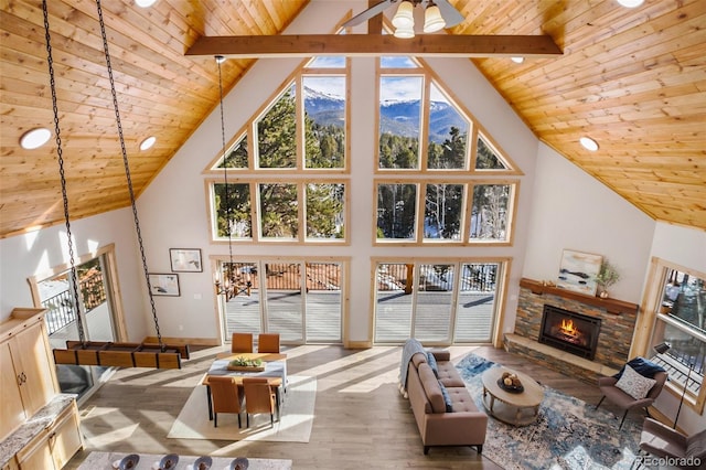 living room featuring beamed ceiling, high vaulted ceiling, and hardwood / wood-style flooring