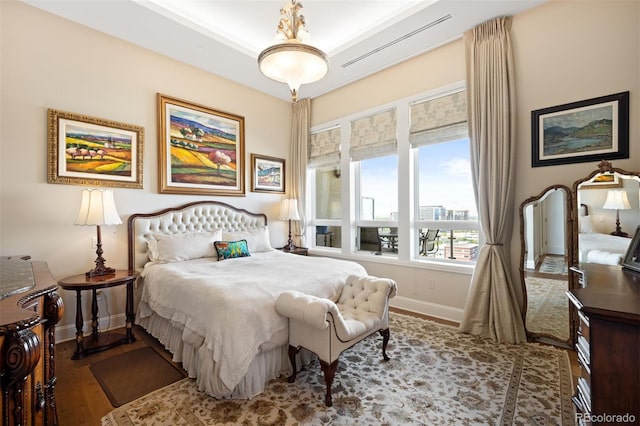 bedroom with baseboards and wood finished floors