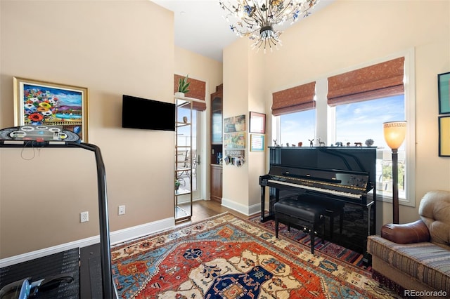 interior space with a chandelier and baseboards