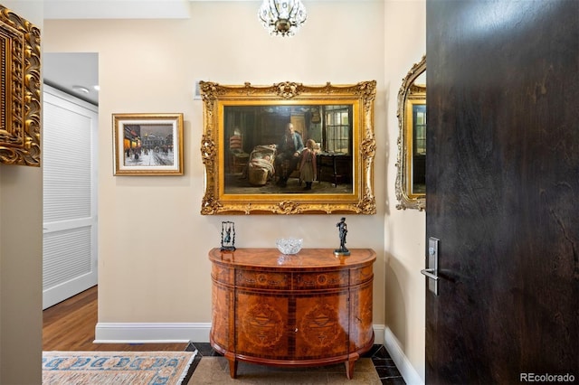 hall featuring baseboards and wood finished floors