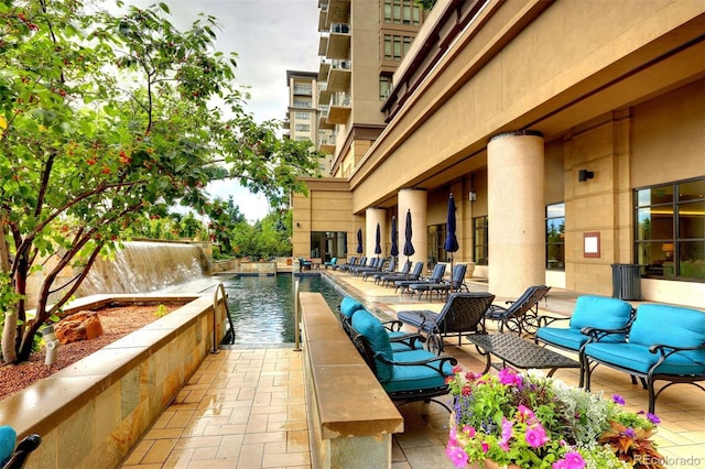 view of patio featuring fence and a community pool