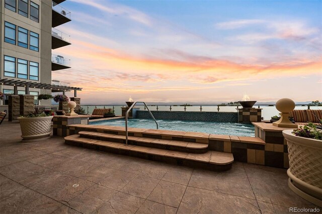 pool at dusk with a water view