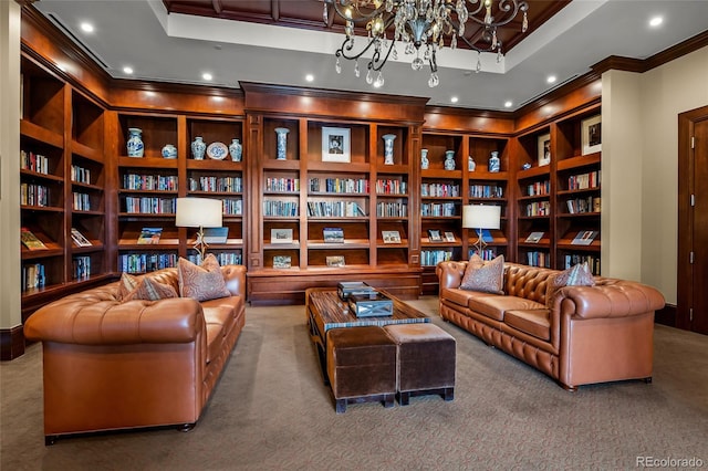 living area featuring carpet floors, an inviting chandelier, built in shelves, and a tray ceiling