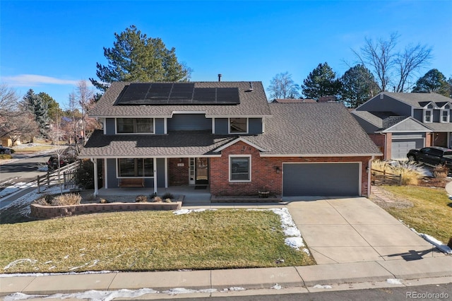 front facade featuring a front lawn, covered porch, a garage, and solar panels