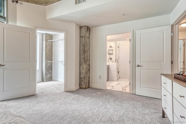 1700 Bassett St Unit 101, Denver, CO 80202 - unfurnished bedroom with light carpet, baseboards, and connected bathroom