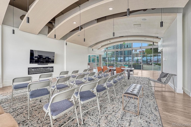 1700 Bassett St Unit 101, Denver, CO 80202 - living room featuring baseboards, wood finished floors, recessed lighting, and vaulted ceiling