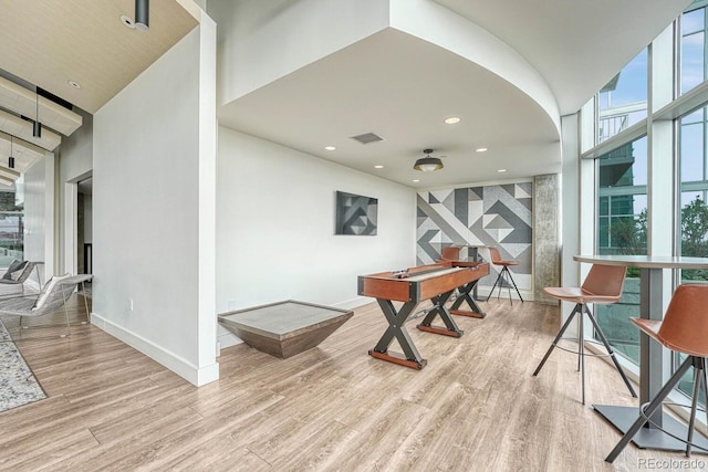 1700 Bassett St Unit 101, Denver, CO 80202 - recreation room with wood finished floors, baseboards, recessed lighting, and a high ceiling