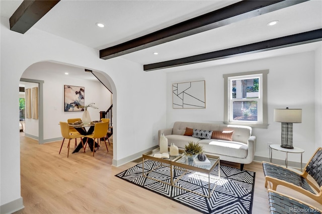 living room featuring light wood-type flooring and beam ceiling