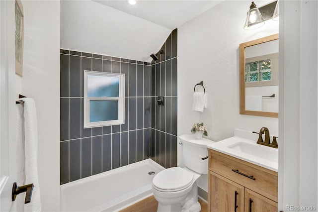 bathroom featuring vanity, toilet, and tiled shower