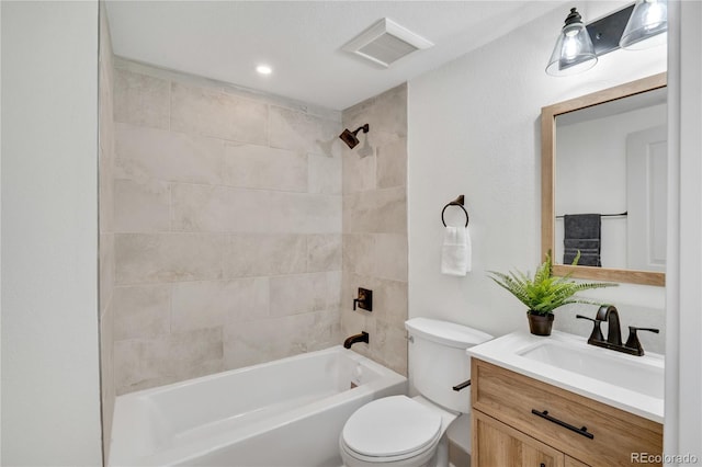 full bathroom featuring vanity, toilet, and tiled shower / bath