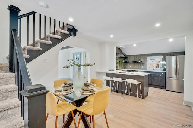 dining area with light hardwood / wood-style floors and sink