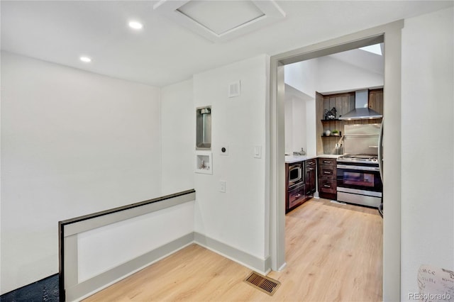 hallway with light hardwood / wood-style floors