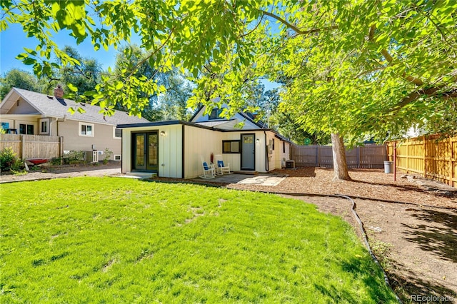 back of property featuring a lawn and a patio area