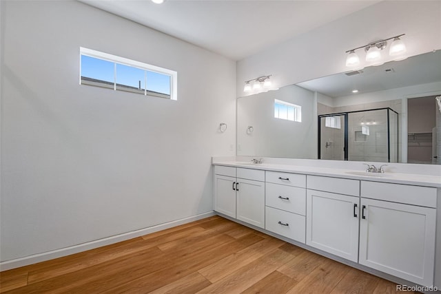 bathroom with vanity, hardwood / wood-style flooring, and an enclosed shower