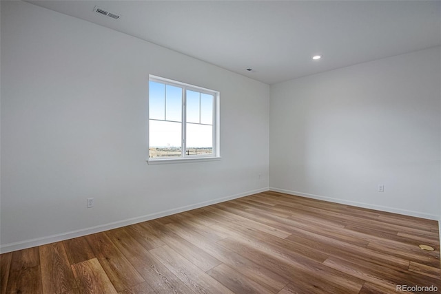 3452 N Gold Bug Ct, Aurora, CO 80019 - spare room featuring wood finished floors, baseboards, and recessed lighting