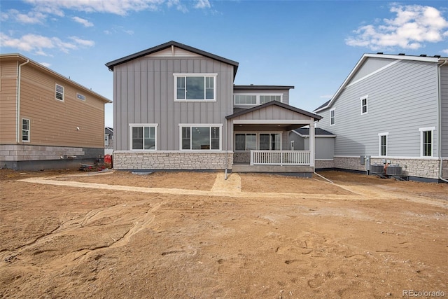 rear view of house with cooling unit and a sunroom