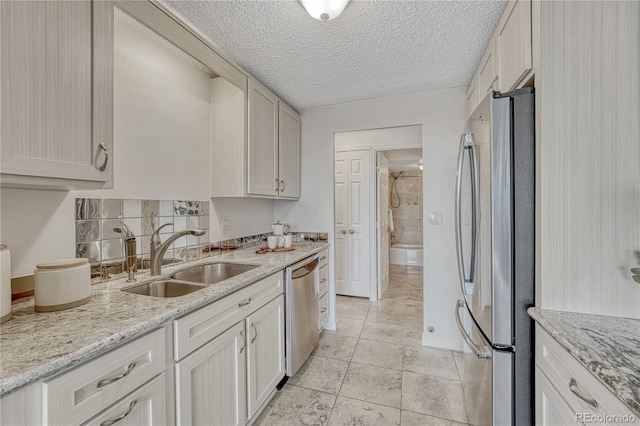 4800 E Hale Pkwy Unit 802N, Denver, CO 80220 - kitchen with appliances with stainless steel finishes, a sink, light tile patterned floors, light stone counters, and baseboards