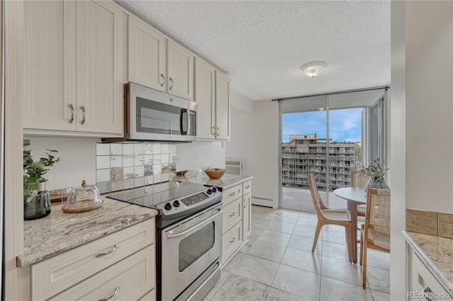 4800 E Hale Pkwy Unit 802N, Denver, CO 80220 - kitchen featuring stainless steel appliances, floor to ceiling windows, a baseboard radiator, a textured ceiling, and light stone countertops