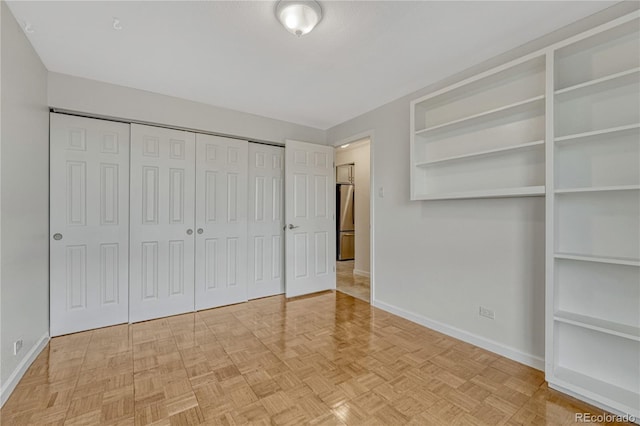4800 E Hale Pkwy Unit 802N, Denver, CO 80220 - unfurnished bedroom with freestanding refrigerator, baseboards, and a closet