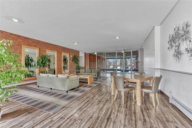 4800 E Hale Pkwy Unit 802N, Denver, CO 80220 - dining room with baseboard heating, wood finished floors, a textured ceiling, brick wall, and recessed lighting
