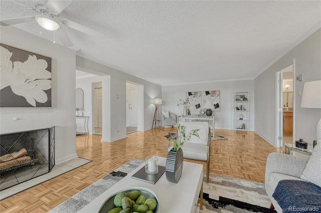 4800 E Hale Pkwy Unit 802N, Denver, CO 80220 - living room with a fireplace with flush hearth, a textured ceiling, ceiling fan, baseboards, and crown molding
