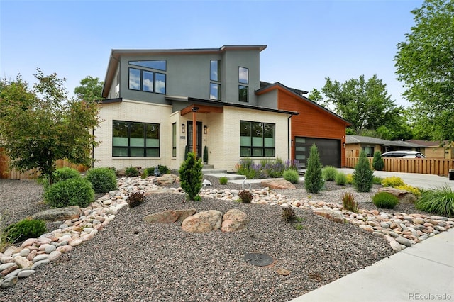 2635 Pierce St, Wheat Ridge, CO 80214 - modern home with an attached garage, brick siding, and stucco siding