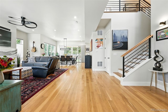 2635 Pierce St, Wheat Ridge, CO 80214 - living area with light wood finished floors, stairs, and recessed lighting