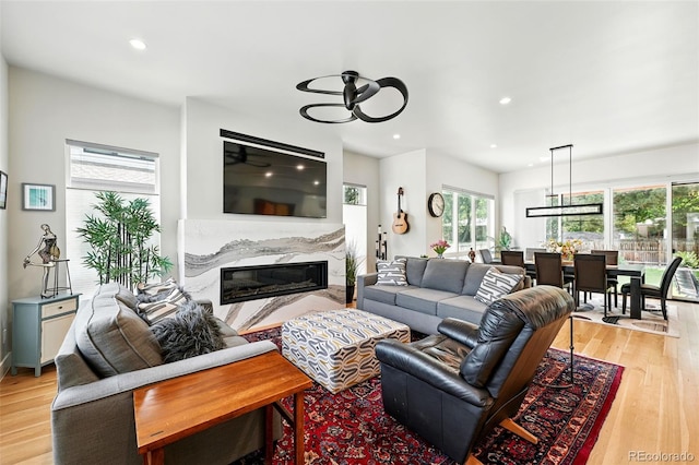 2635 Pierce St, Wheat Ridge, CO 80214 - living area featuring a premium fireplace, ceiling fan, light wood-type flooring, and recessed lighting