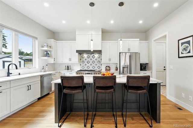2635 Pierce St, Wheat Ridge, CO 80214 - kitchen featuring stainless steel appliances, a kitchen island, backsplash, white cabinets, and recessed lighting