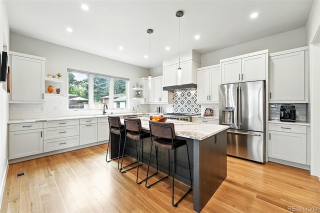 2635 Pierce St, Wheat Ridge, CO 80214 - kitchen with stainless steel fridge with ice dispenser, open shelves, tasteful backsplash, a center island, and recessed lighting