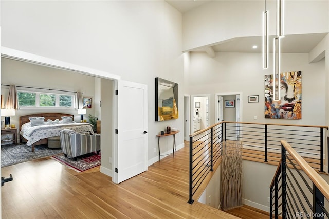 2635 Pierce St, Wheat Ridge, CO 80214 - corridor with an upstairs landing, a towering ceiling, and light wood-style floors