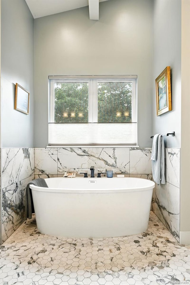 2635 Pierce St, Wheat Ridge, CO 80214 - bathroom with tile walls, a freestanding bath, and wainscoting