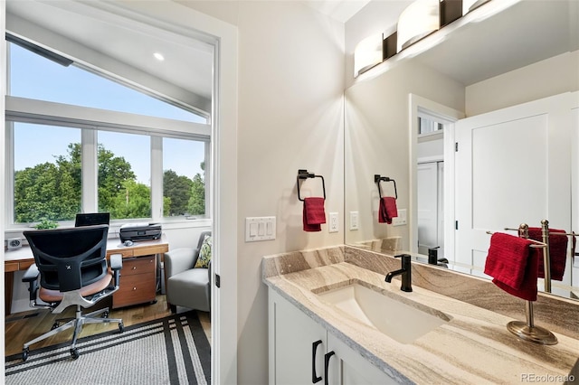 2635 Pierce St, Wheat Ridge, CO 80214 - bathroom with vanity, wood finished floors, and recessed lighting