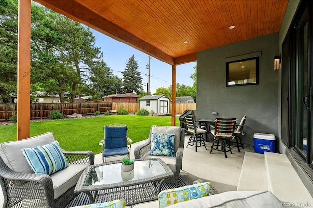 2635 Pierce St, Wheat Ridge, CO 80214 - fenced backyard featuring an outdoor living space, a storage unit, a patio area, and outdoor dining area